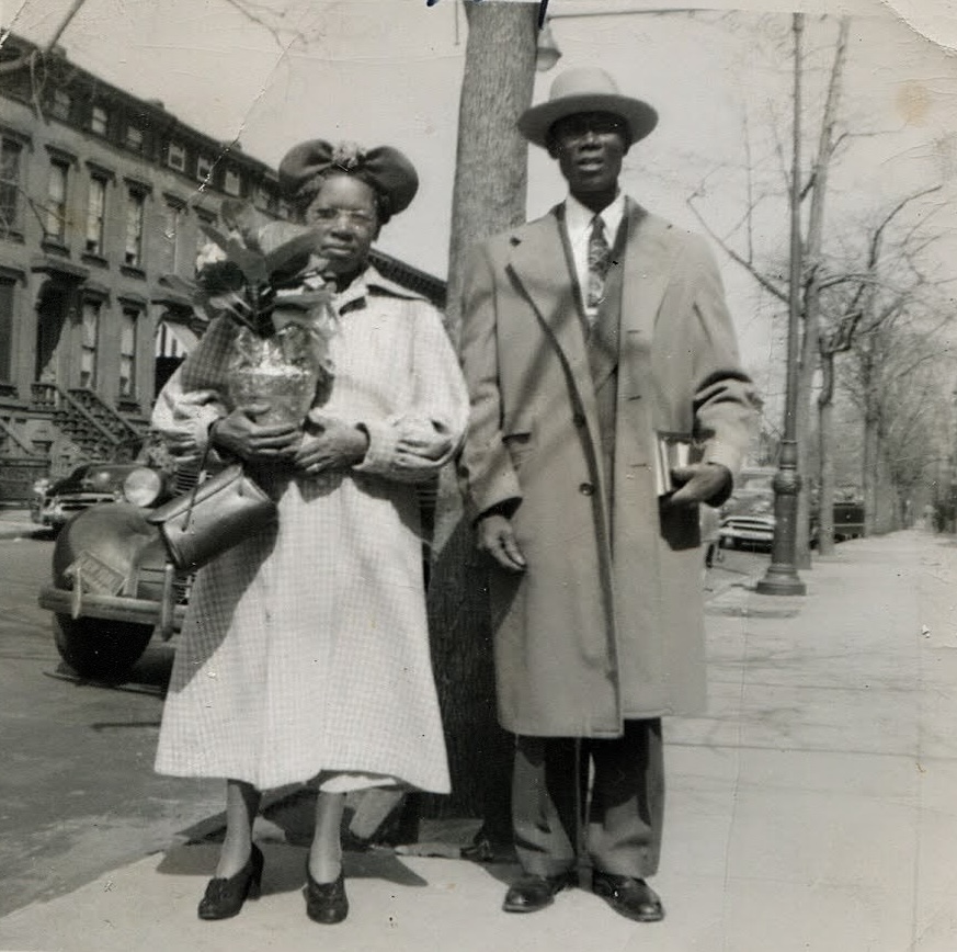 Grandma and Pop on a Bed-Stuy block, 1954