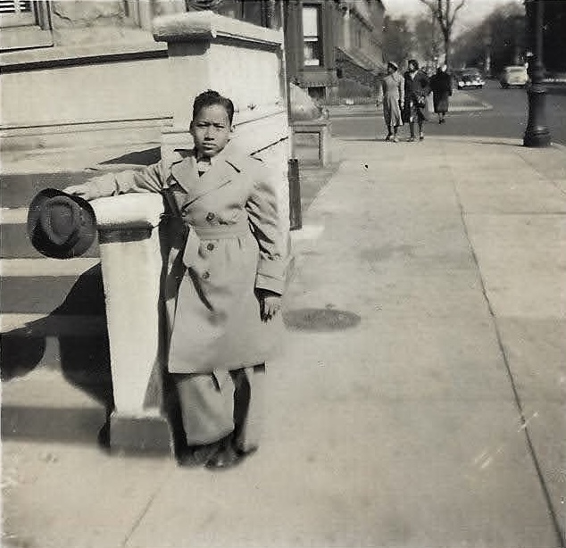 Young person on a Bed-Stuy stoop, mid-20th century